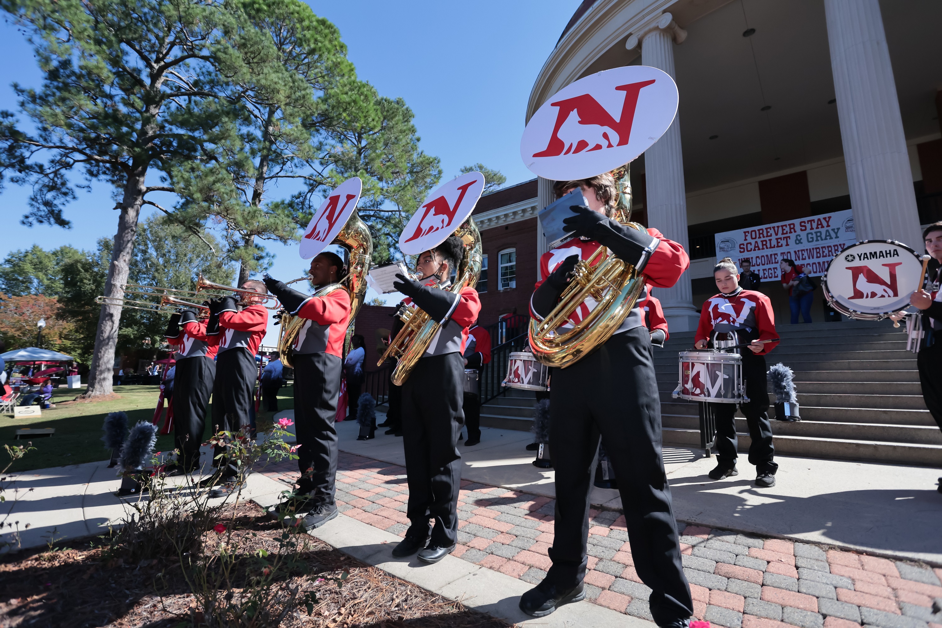 Sousaphone players in the Scarlet Spirit Marching Band perform at a pep rally