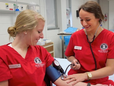 two nursing students taking blood pressure